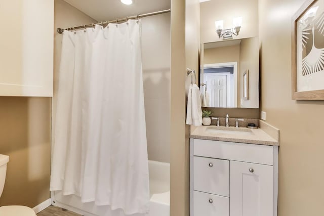 bathroom with vanity, toilet, and shower / tub combo