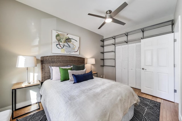 bedroom featuring ceiling fan, a closet, and wood finished floors