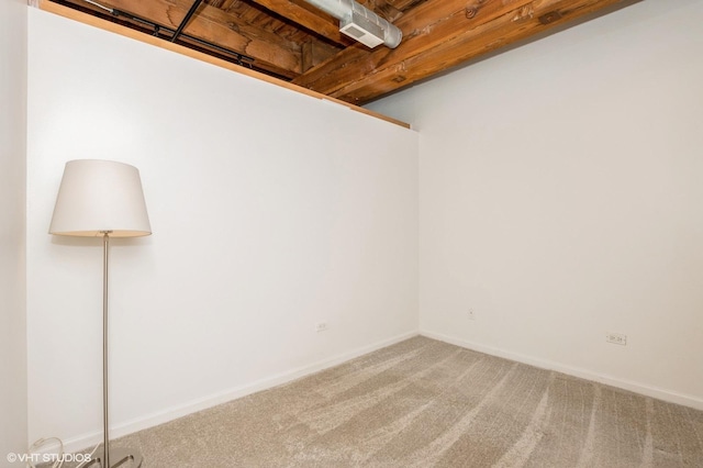 unfurnished room with baseboards and carpet floors