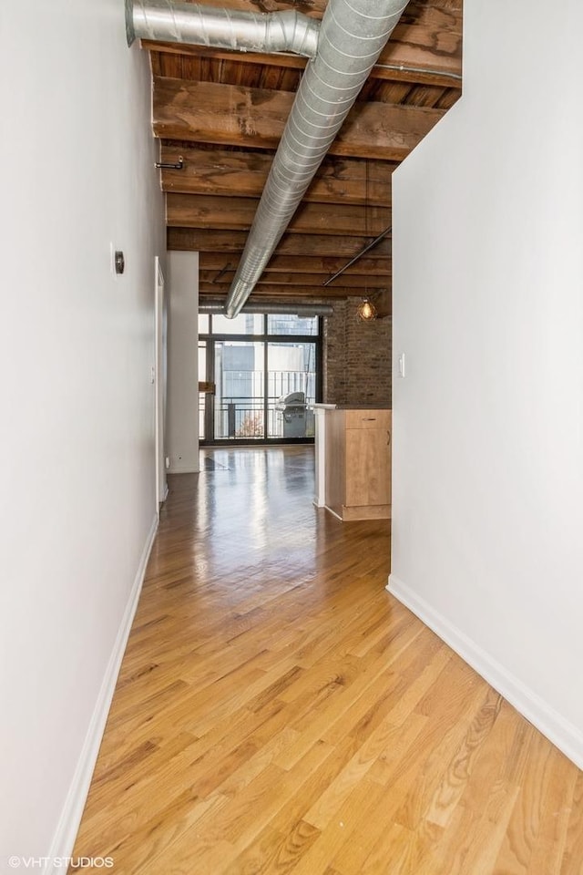 interior space with baseboards and wood finished floors
