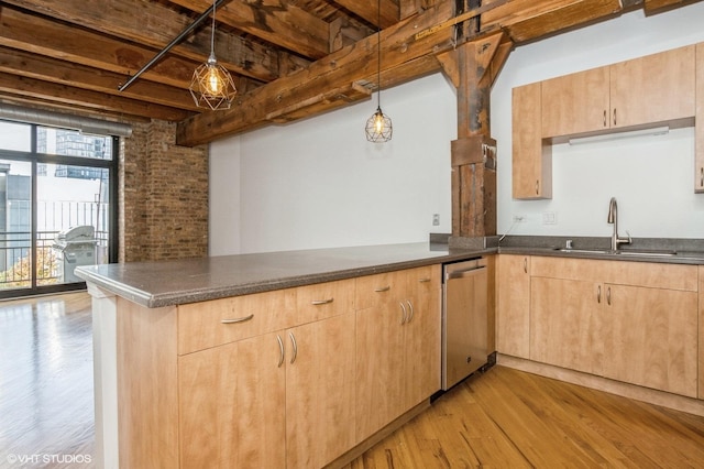 kitchen with a sink, a peninsula, dishwasher, light brown cabinets, and light wood-style floors