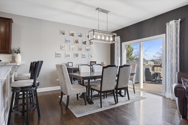 dining area with baseboards and dark wood-style flooring