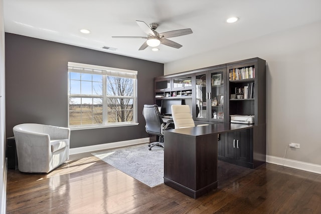 office featuring visible vents, baseboards, ceiling fan, and dark wood-style flooring