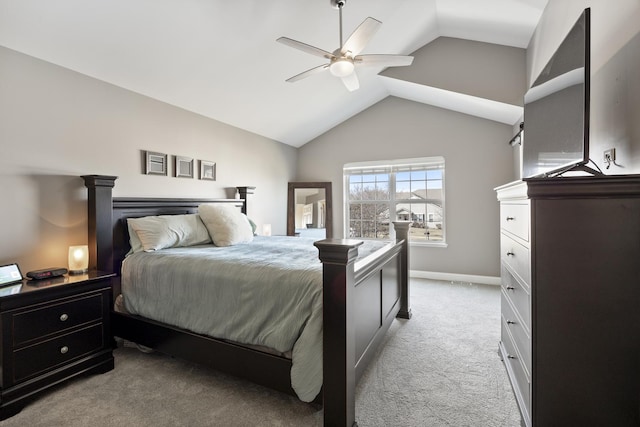 bedroom featuring light colored carpet, baseboards, lofted ceiling, and ceiling fan