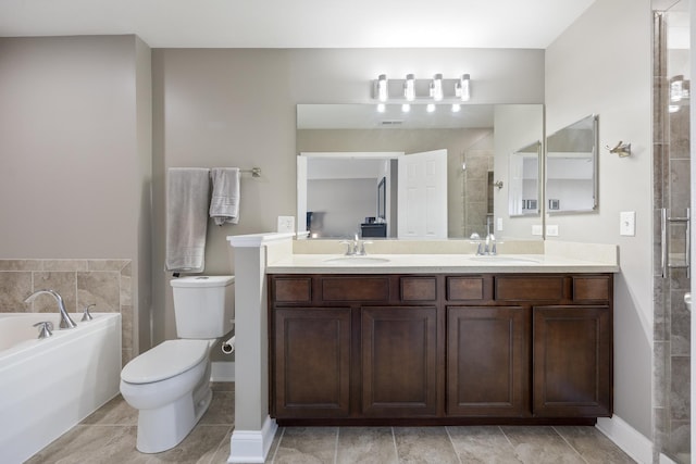 bathroom with a garden tub, toilet, a stall shower, and a sink