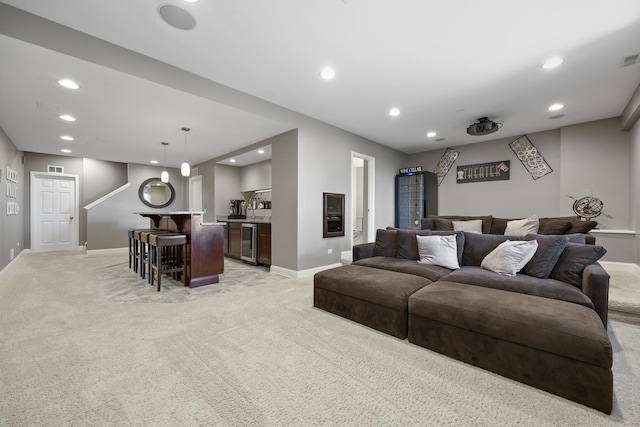 living room with light carpet, recessed lighting, wine cooler, wet bar, and baseboards