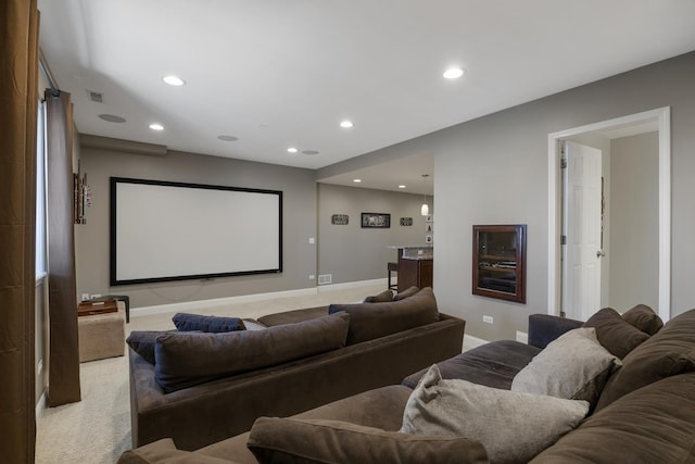 home theater featuring recessed lighting, light colored carpet, visible vents, and baseboards