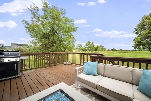 wooden deck with outdoor lounge area and area for grilling