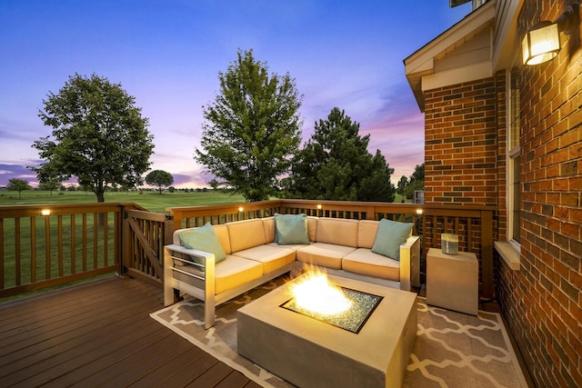 wooden deck with an outdoor living space with a fire pit