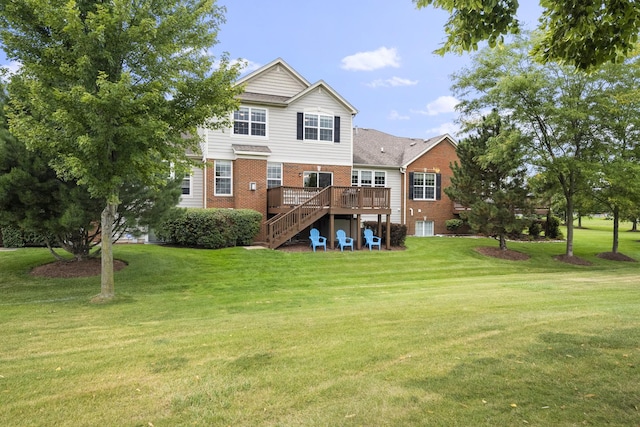 back of house with a yard, brick siding, a deck, and stairs