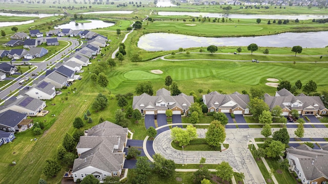 birds eye view of property featuring golf course view, a water view, and a residential view