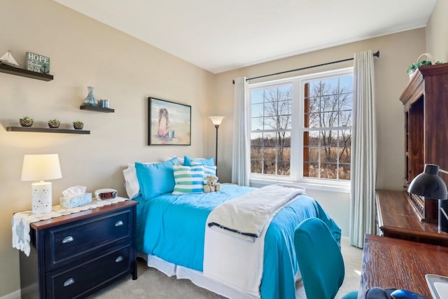 bedroom featuring light colored carpet and baseboards