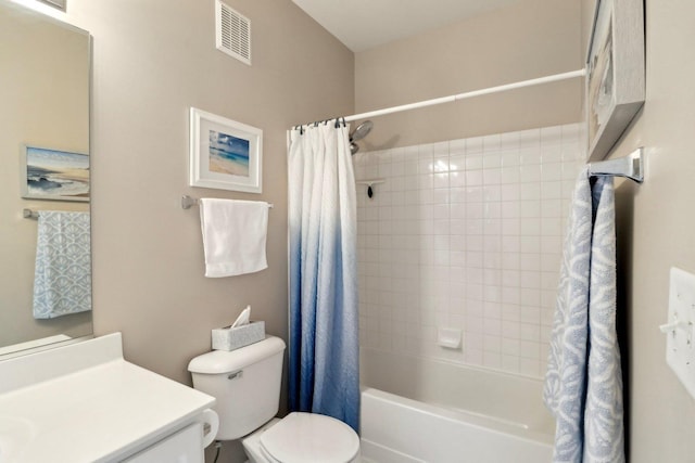 bathroom with visible vents, toilet, vanity, and shower / bath combo