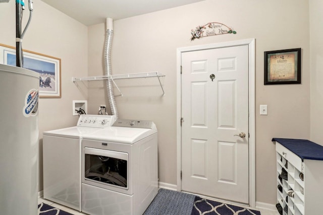 laundry area featuring baseboards, independent washer and dryer, laundry area, and water heater