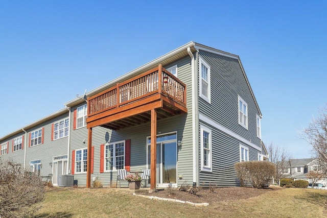 back of house featuring a yard and central AC