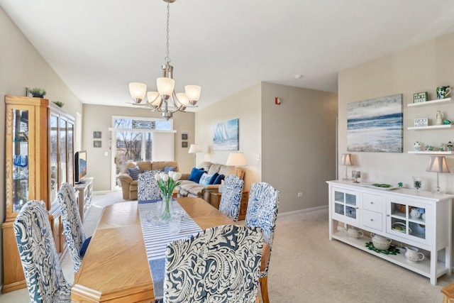 dining room with an inviting chandelier, baseboards, and light carpet