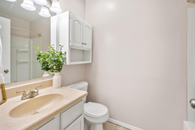 bathroom featuring vanity, baseboards, tile patterned flooring, a shower, and toilet