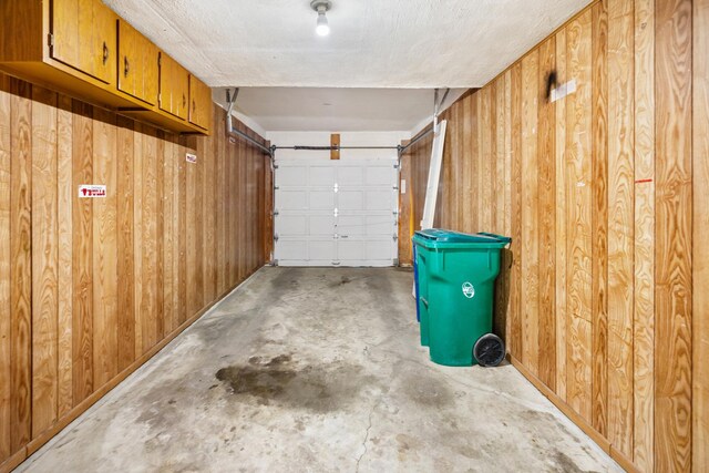 garage featuring wood walls