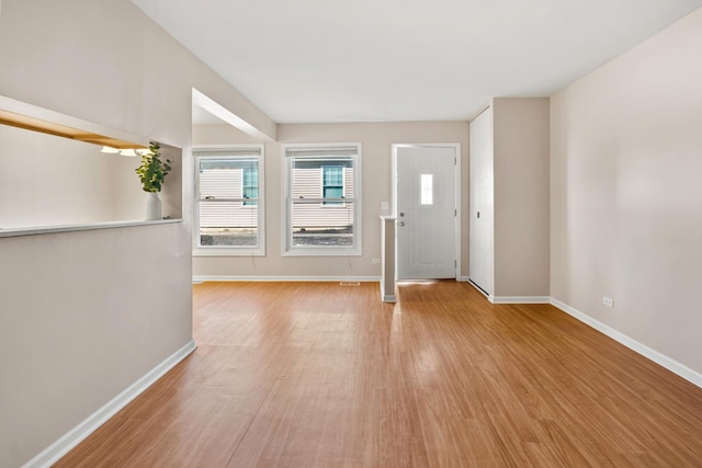 entryway with baseboards and light wood-style floors