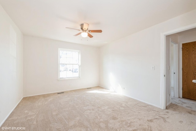 unfurnished room with baseboards, carpet floors, and a ceiling fan