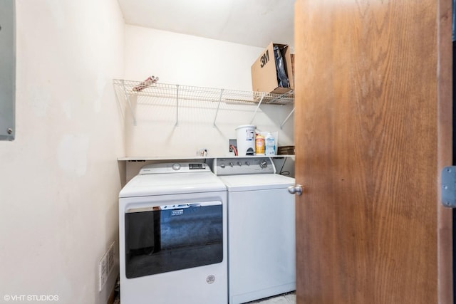 clothes washing area featuring laundry area, visible vents, and washer and clothes dryer