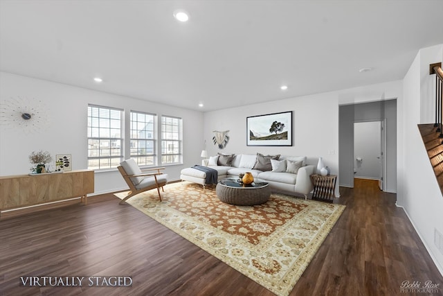 living area featuring recessed lighting, baseboards, and dark wood-type flooring