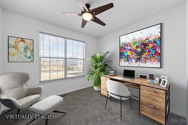 office area featuring visible vents, baseboards, ceiling fan, and dark carpet