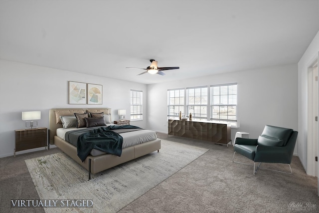 carpeted bedroom featuring multiple windows, baseboards, and a ceiling fan