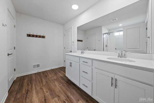 bathroom with a shower stall, visible vents, and a sink