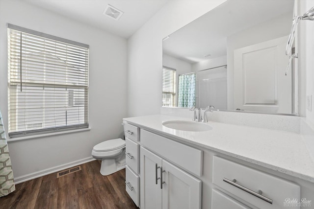 full bathroom featuring vanity, toilet, wood finished floors, and visible vents