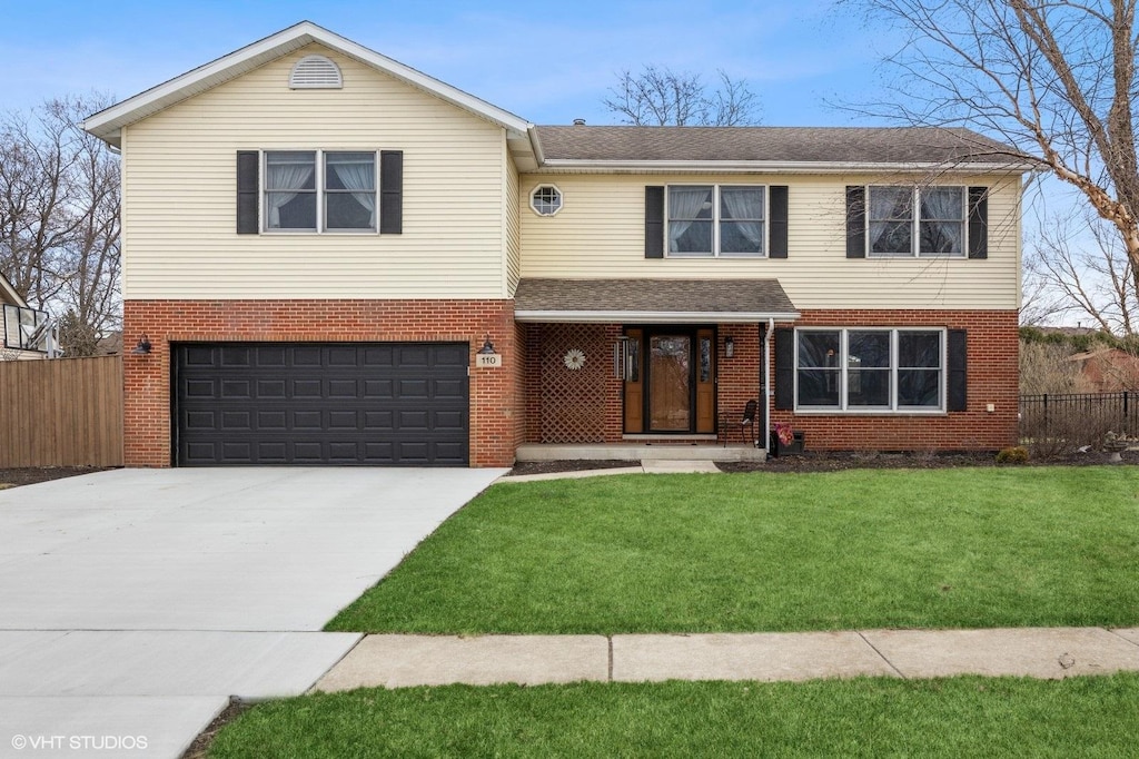 view of front of property with driveway, brick siding, fence, and a front yard