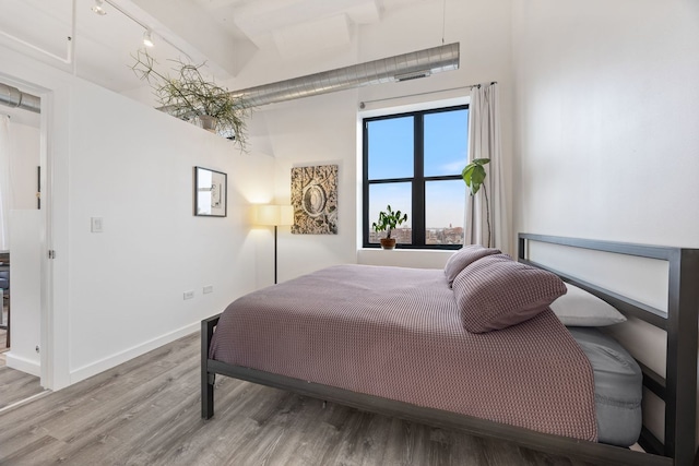 bedroom with baseboards and light wood finished floors