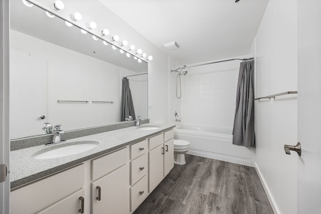 bathroom featuring double vanity, wood finished floors, shower / tub combo with curtain, and a sink