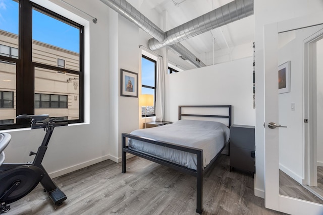 bedroom with wood finished floors and baseboards