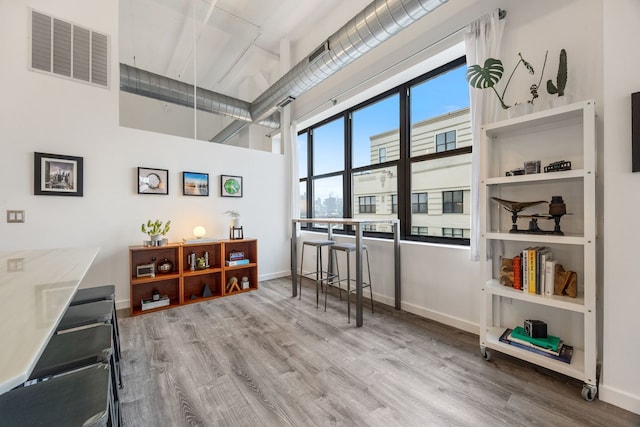 interior space with visible vents, baseboards, and wood finished floors