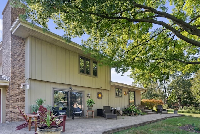 back of property featuring a patio and a chimney