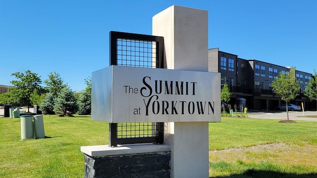 community sign featuring a lawn