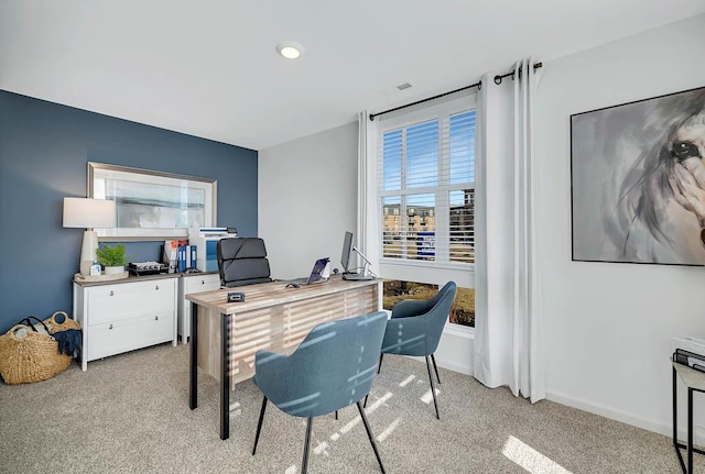 office area featuring light carpet and baseboards
