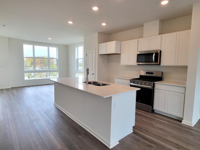 kitchen featuring a sink, white cabinets, dark wood finished floors, and stainless steel appliances