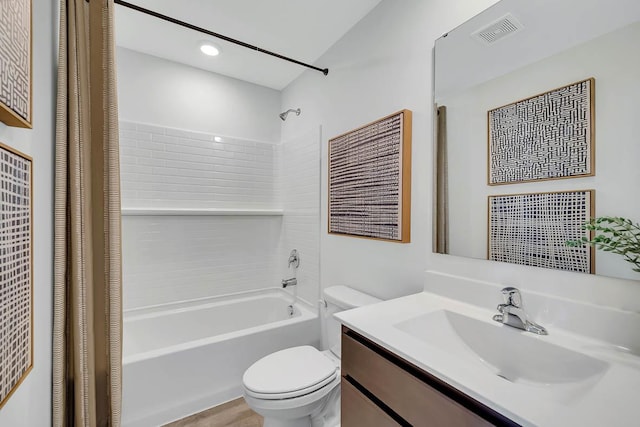 bathroom with visible vents, vanity, toilet, and shower / tub combo with curtain