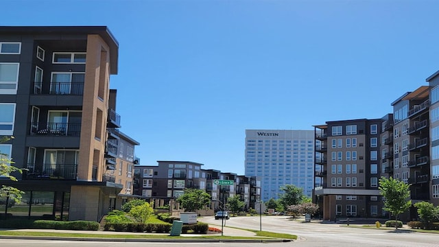 exterior space featuring curbs, traffic signs, and sidewalks