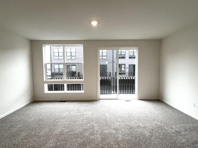 carpeted spare room with baseboards