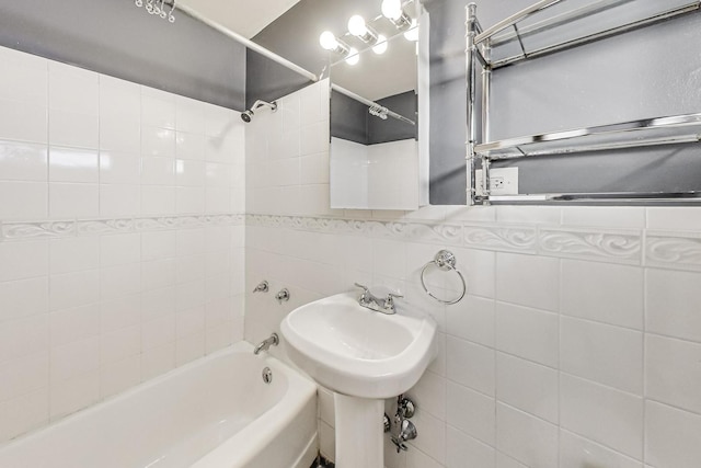 bathroom featuring tile walls and shower / bathtub combination