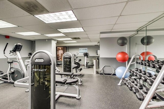 exercise room with a drop ceiling