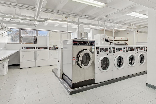 community laundry room featuring light tile patterned floors and separate washer and dryer