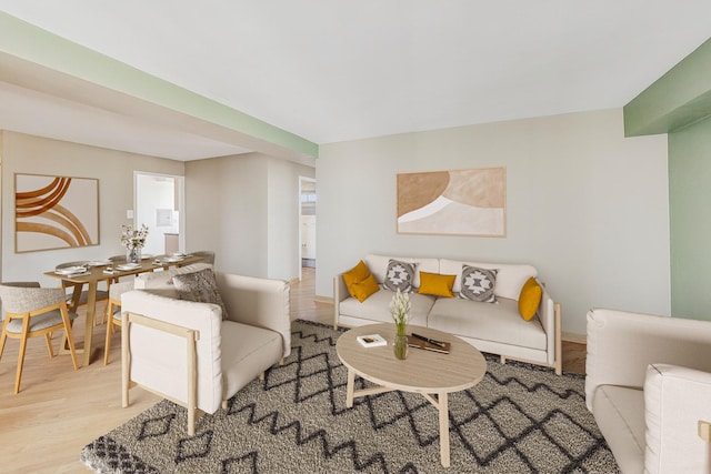 living area featuring baseboards and light wood-style floors