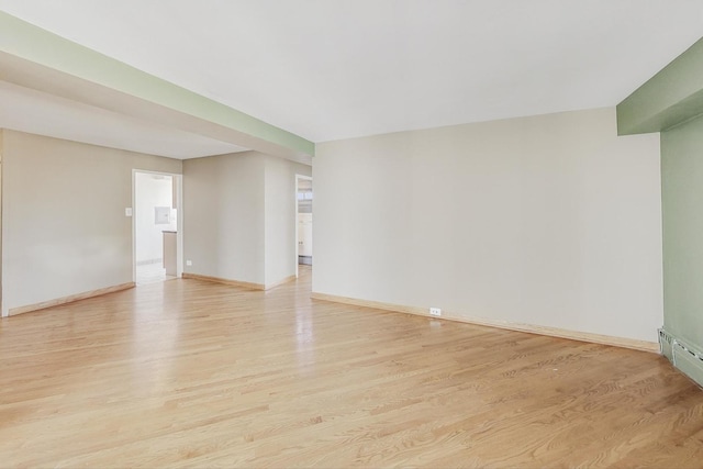 spare room with light wood-style flooring and baseboards