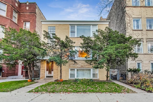 multi unit property with brick siding and a gate