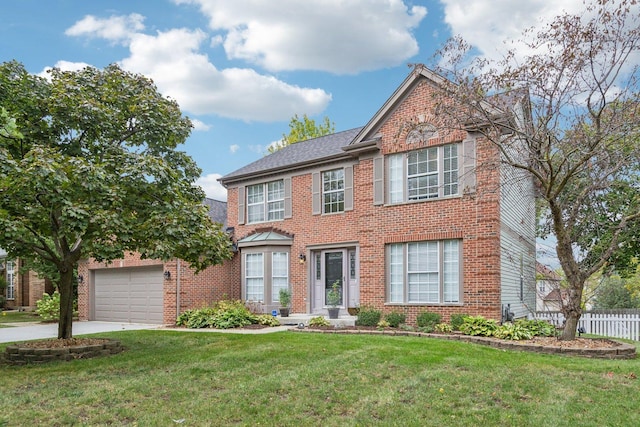 view of front facade with driveway, fence, a front yard, an attached garage, and brick siding