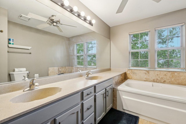 bathroom with a ceiling fan, a wealth of natural light, and a sink